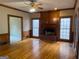 Cozy living room with hardwood floors, fireplace, ceiling fan, and large windows for great natural light at 823 Mountain View Run, Stone Mountain, GA 30087