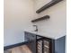 This bar area features dark cabinetry, a white countertop, floating shelves, and a wine refrigerator at 105 Robinwood Ct, Fayetteville, GA 30214