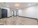 Spacious finished basement with wood floor, recessed lights, black door and base trim at 105 Robinwood Ct, Fayetteville, GA 30214