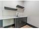 Modern bathroom vanity with quartz countertop, black cabinets with gold hardware, and open shelving at 105 Robinwood Ct, Fayetteville, GA 30214