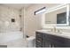 Beautiful bathroom with marble tile, white vanity with gold hardware, and lighted mirror at 105 Robinwood Ct, Fayetteville, GA 30214