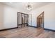 This bedroom has hardwood floors, a modern light fixture, and a clear glass door to another room at 105 Robinwood Ct, Fayetteville, GA 30214