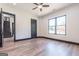 Spacious bedroom with a ceiling fan, hardwood floors, and a large window overlooking the backyard at 105 Robinwood Ct, Fayetteville, GA 30214