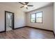 Bedroom with wood floor, large window, ceiling fan, and black base trim at 105 Robinwood Ct, Fayetteville, GA 30214