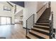 Elegant entryway featuring a modern staircase, hardwood floors, and open-concept living space at 105 Robinwood Ct, Fayetteville, GA 30214