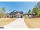Beautiful two-story home featuring stone and modern architectural details with an expansive driveway at 105 Robinwood Ct, Fayetteville, GA 30214