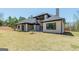 Rear exterior view displaying the home's design, roofline, and yard space at 105 Robinwood Ct, Fayetteville, GA 30214