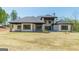 Wide view of the home's rear exterior, lawn, and outdoor living spaces at 105 Robinwood Ct, Fayetteville, GA 30214