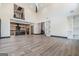 Open-concept living area featuring hardwood floors, soaring ceilings, and a view of the modern kitchen at 105 Robinwood Ct, Fayetteville, GA 30214