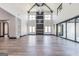 Large living room with soaring ceilings, hardwood floors, and modern design elements at 105 Robinwood Ct, Fayetteville, GA 30214