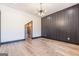 Modern living room with wood floors, decorative accent wall and access to wine room at 105 Robinwood Ct, Fayetteville, GA 30214