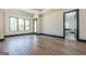 Bright main bedroom featuring hardwood floors, large windows, and an ensuite bathroom at 105 Robinwood Ct, Fayetteville, GA 30214