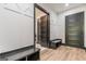Hallway with mudroom lockers and seating, and hardwood-style floors, accented by black trim and white wainscotting at 105 Robinwood Ct, Fayetteville, GA 30214