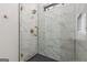 Shower with marble tile, glass door and gold hardware at 105 Robinwood Ct, Fayetteville, GA 30214