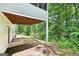 View of backyard area with ground-level patio beneath a screened porch, offering outdoor relaxation and entertainment space at 345 Sharon Dr, Fayetteville, GA 30214