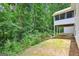Backyard featuring a screened porch, providing shaded outdoor space and a connection to the lush greenery surrounding the property at 345 Sharon Dr, Fayetteville, GA 30214