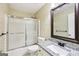 Bathroom showcasing a shower-tub combo, patterned wallpaper, and granite vanity at 345 Sharon Dr, Fayetteville, GA 30214