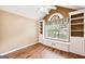 Bright bedroom with hardwood floors, built-in shelving, window seat, and ceiling fan at 345 Sharon Dr, Fayetteville, GA 30214