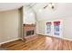 Bright living room featuring a brick fireplace, vaulted ceilings, and wood floors at 345 Sharon Dr, Fayetteville, GA 30214