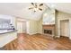 Spacious living room with a brick fireplace, vaulted ceilings, and modern flooring at 345 Sharon Dr, Fayetteville, GA 30214