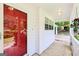 Inviting porch with a red glass door, decorative lanterns and mosaic tile flooring at 345 Sharon Dr, Fayetteville, GA 30214