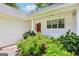 Cozy front porch with red door, white railings, and decorative hanging lanterns at 345 Sharon Dr, Fayetteville, GA 30214