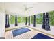 Relaxing screened porch with light wood floors, large windows, and ceiling fan at 345 Sharon Dr, Fayetteville, GA 30214