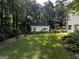 Picturesque backyard with a detached garage surrounded by a well-manicured lawn and mature trees at 3970 Governors Cir, Loganville, GA 30052