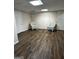 Finished basement with wood-look flooring and two wicker chairs at 3970 Governors Cir, Loganville, GA 30052