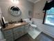 Charming bathroom featuring granite countertops and a decorative mirror adding a touch of elegance at 3970 Governors Cir, Loganville, GA 30052