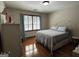 Bedroom featuring wood floors, a bright window, and a neatly made bed with blue and white bedding at 3970 Governors Cir, Loganville, GA 30052