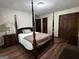 Bedroom with hardwood floors, dark wood trim and ample closet space for storage at 3970 Governors Cir, Loganville, GA 30052