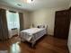 A cozy bedroom with hardwood floors, natural light, and a charming bed with a patterned quilt at 3970 Governors Cir, Loganville, GA 30052