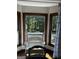 Bay window seating with views of the outside trees and custom window treatments at 3970 Governors Cir, Loganville, GA 30052