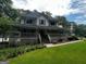 Charming two-story home with a full wrap-around porch and lush landscaping at 3970 Governors Cir, Loganville, GA 30052