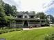 Charming two-story home with a large wraparound porch and well-manicured lawn at 3970 Governors Cir, Loganville, GA 30052