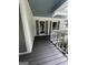 Charming front porch featuring gray wood floors and white siding and trim work at 3970 Governors Cir, Loganville, GA 30052