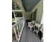 Inviting covered front porch with wicker seating and serene outdoor views at 3970 Governors Cir, Loganville, GA 30052