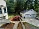 View of a detached two-car garage and landscaped backyard at 3970 Governors Cir, Loganville, GA 30052