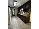 The kitchen features dark wood cabinetry, stainless steel appliances, and granite countertops at 3970 Governors Cir, Loganville, GA 30052
