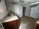 Basement kitchenette featuring sink, counter space, and ample storage, adjacent to laundry room at 3970 Governors Cir, Loganville, GA 30052