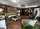 Cozy living room with wood paneling and wood laminate flooring at 3970 Governors Cir, Loganville, GA 30052