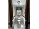 The powder room has neutral-toned walls and a white-tiled floor at 3970 Governors Cir, Loganville, GA 30052
