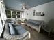 Sunroom with wicker sofas and chairs under a blue ceiling at 3970 Governors Cir, Loganville, GA 30052