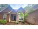 Inviting home with stone accents, stucco siding, arched window, and a covered entryway, complemented by tidy landscaping at 455 Old Ivy Path, Mcdonough, GA 30253