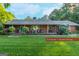 Charming single-story brick home with lush landscaping, and welcoming front porch at 8815 Campbellton St, Douglasville, GA 30134