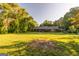 Expansive lawn surrounding a brick house, shaded by large trees at 8815 Campbellton St, Douglasville, GA 30134