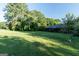 Charming home featuring a lush green lawn, mature trees, and a traditional brick exterior at 8815 Campbellton St, Douglasville, GA 30134