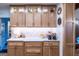 Charming kitchen with light wood cabinetry, stone countertops, under-cabinet lighting, and stylish decor at 8815 Campbellton St, Douglasville, GA 30134