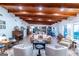 Expansive living room with wood ceilings, showcasing comfortable seating areas, a piano, and seamless flow to the kitchen at 8815 Campbellton St, Douglasville, GA 30134